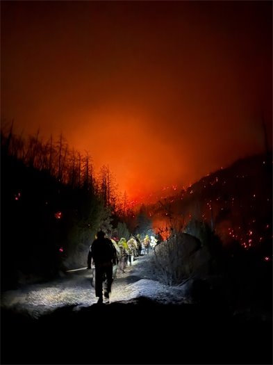 Firefighters hiking at night during the Pickett Fire